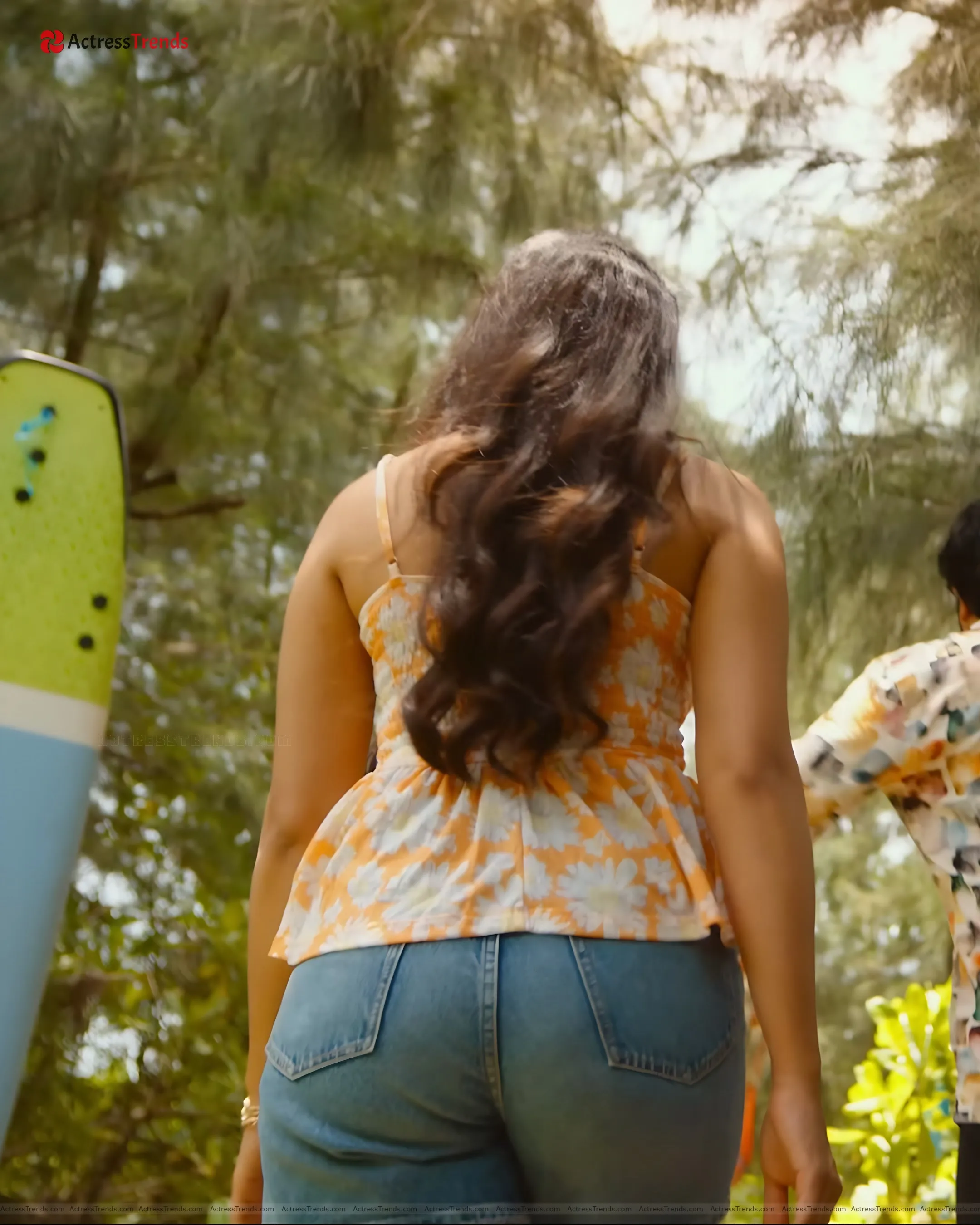 Rukmini Vasanth Yellow Dress Tight Fitting Beach Back Pose